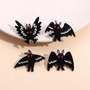 Gothic Mothman enamel pin set featuring four unique black poses with red eyes