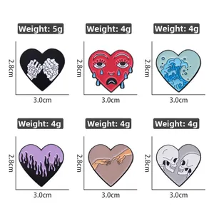 Detailed view of heart-shaped enamel pins featuring skull, wave, and flame designs
