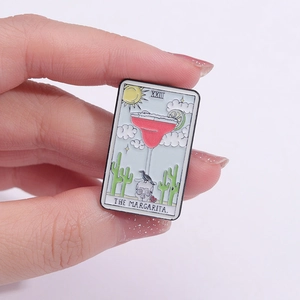 Detail of The Margarita tarot card enamel pin featuring a cocktail and skull design
