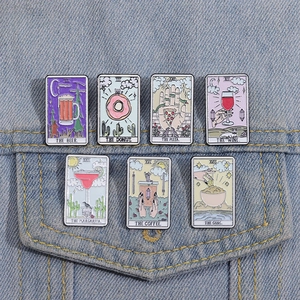Close-up of food-themed tarot enamel pins on denim jacket showing creative artistic details