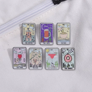 Detailed close-up of tarot style enamel pins featuring diverse food and drink motifs