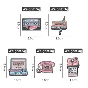 Detailed size and weight view of pink retro enamel pins set featuring camera and radio