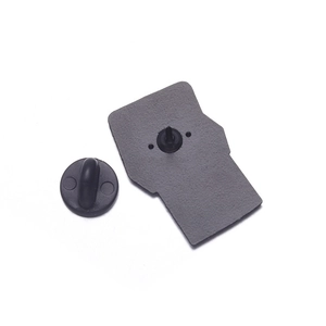 Detail view of the metal brooch back with sandblasted finish and black rubber pin clutch