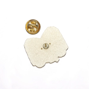 Back view of gold metal book brooch showing pin clasp and butterfly clutch detail