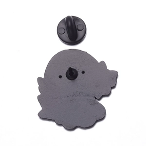 Detail view of the enamel pin back with black rubber clutch and matte metal texture