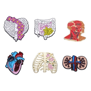Anatomy enamel pin set with floral motifs including ribs, heart, and trust your gut text