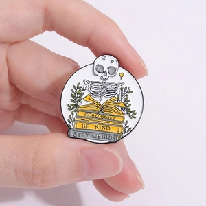 Enamel skull reading books pin with Stay Weird and Be Kind quotes on metal badge