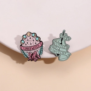 Enamel witch pins featuring Lunar Witch moon and Just a Little Witchy bottle designs