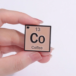 Minimalistische emaille broche met koffie-element en Co-chemisch symbool in vierkant