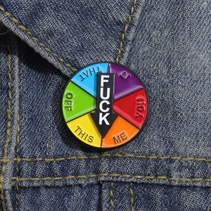 Rotating enamel social mood pin with arrow on denim jacket, creative interactive badge