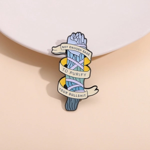 Enamel sage bundle brooch with ribbon and humorous text on minimalist beige background