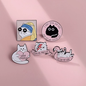 Macro detail of five unique enamel cat pins featuring creative artistic parodies