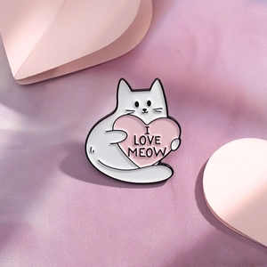 Detailed close-up of a white enamel cat brooch holding a pink heart with I Love Meow text
