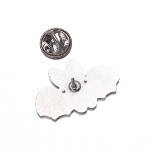 Detail view of the black bat metal brooch back with secure silver butterfly clutch
