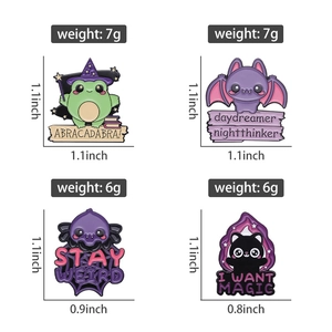 Close-up of four magical enamel pins featuring a wizard frog, bat, and spider web motif