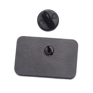 Macro detail of the metal enamel pin back with secure black rubber clutch and needle