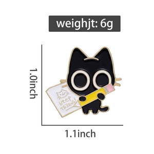 Detail of cute black cat enamel pin with Keep Trying text and pencil design
