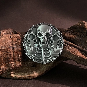Detailed macro view of skull and dual pistols design on a retro silver metal brooch