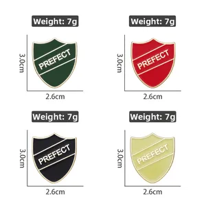 Detail view of four colorful shield metal badges with 'PREFECT' text engraving
