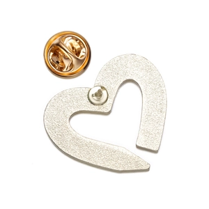 Detailed back view of heart brooch with golden butterfly clutch and matte alloy texture