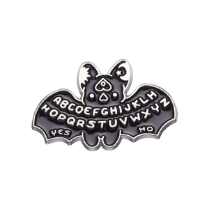 Cartoon gothic bat enamel pin with alphabet letters and Ouija board mystic symbols