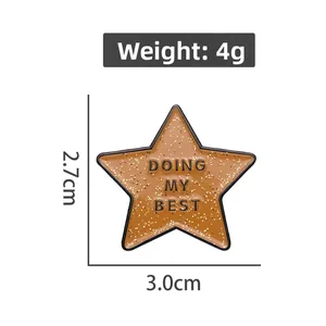 Detail of star-shaped enamel pin badge with 'Doing My Best' text and dimensions