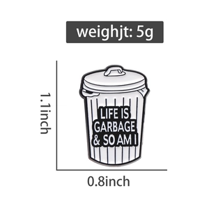 Detailed view of enamel trash bin pin with dimensions 1.1x0.8 inches and 5g weight