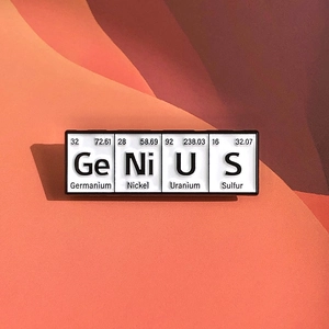 Close-up of a black enamel pin with Genius chemical element periodic table design