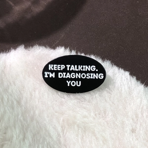 Funny enamel pin badge with 'Keep talking. I'm diagnosing you' quote on black background