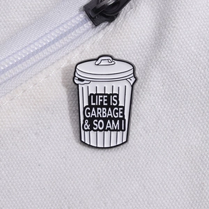 Trash can enamel pin with 'Life is Garbage' text on white canvas background