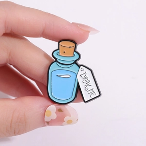Cartoon enamel potion bottle pin with 'DRINK ME' label for Halloween accessory