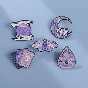 Set of five purple occult enamel pins featuring moth moon and crystal ball designs