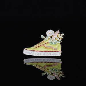 Creative yellow sneaker enamel brooch with white flowers and every step is growth text