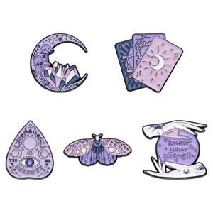 Set of 5 purple enamel pins with moon, tarot, moth, and crystal ball designs on white background