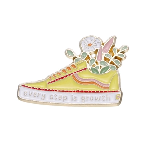 Floral canvas sneaker enamel pin with Every Step is Growth quote in yellow and gold