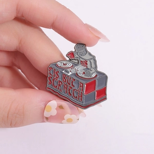 Funny Black Knight DJ enamel pin with Tis But A Scratch text on a pink background