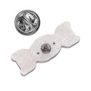Detailed back view of DNA metal badge showing sandblasted texture and butterfly clutch
