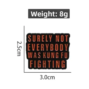 Detail showing an enamel brooch with Kung Fu Fighting quote and size measurements
