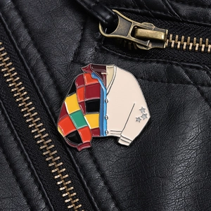 Detail of colorful patchwork jacket enamel brooch with star accents on leather jacket