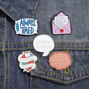 Set of 5 geometric alloy enamel brooches featuring various shapes pinned on a denim jacket