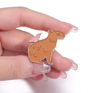 Cute cartoon capybara enamel pin with pink bird, handcrafted metal badge accessory