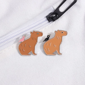 Cute capybara enamel pins with colorful birds on a white canvas bag accessory