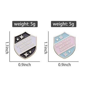 Detail view of Pointless Meeting Survivor enamel pins in black and blue metal finishes