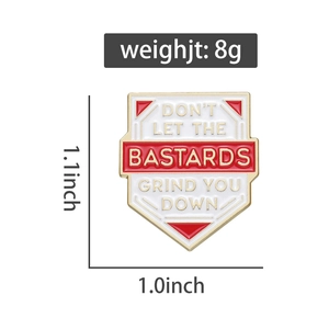 Detailed view of shield enamel pin with dimensions 1.1x1.0 inches and 8g weight