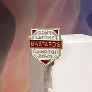 Cartoon shield enamel pin badge with motivational text on minimalist geometric stand