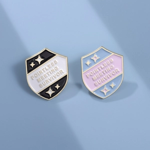 Funny Pointless Meeting Survivor shield enamel pins in black and blue metal finishes
