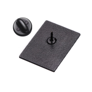Detailed back view of a matte black rectangular enamel pin with a rubber clutch fastener