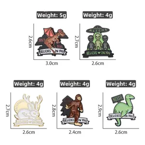 Detailed view of five cartoon enamel pins featuring Bigfoot and Alien mythical creatures