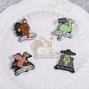 5-piece mystical creature enamel pin set featuring Bigfoot, Mothman and Alien designs