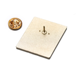 Detail view of the metal brooch back featuring a butterfly clasp and matte gold finish